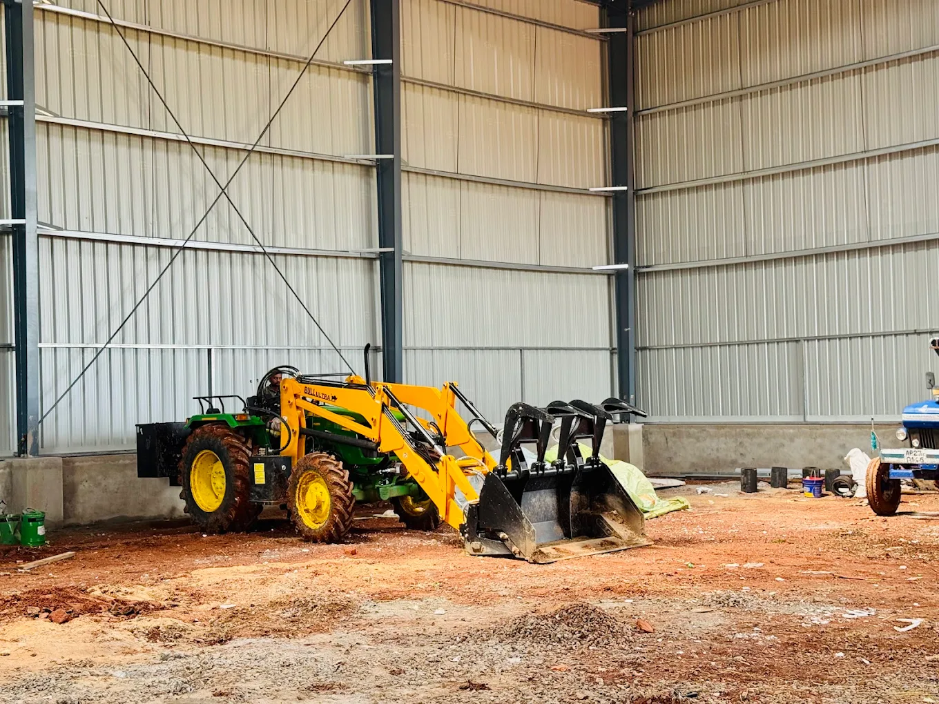 Loader tractor moving biomass raw material at Sri Parameswara plant